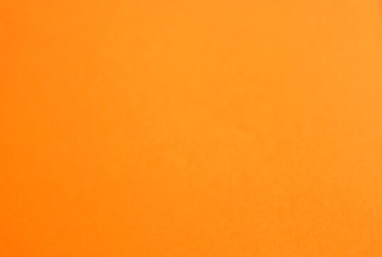 Orange paper background with empty copy space for text. Minimalist backdrop. Empty template design