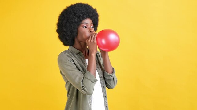 Adorable glad excited lady laugh enjoy inflating balloon