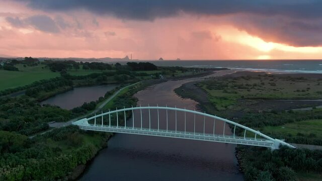 Aerial: Te Rewa Rewa Bridge at sunset, New Plymouth, Taranaki, New Zealand