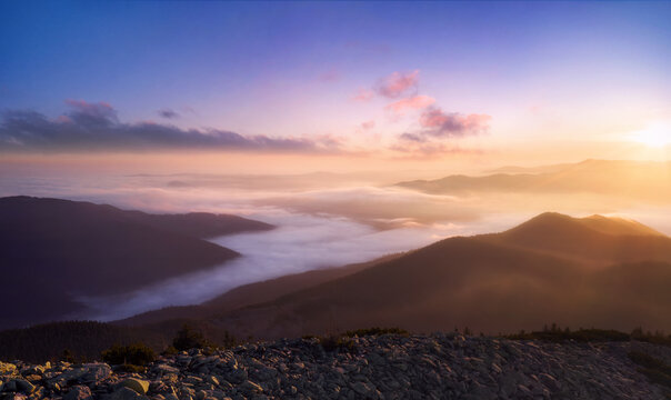 MColorful landscape of foggy mountains at sunrise with dramatic soft light. Aerial view.