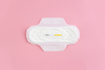 Сlean feminine sanitary napkin with an unused express FSH test. The minimum concept of the absence...