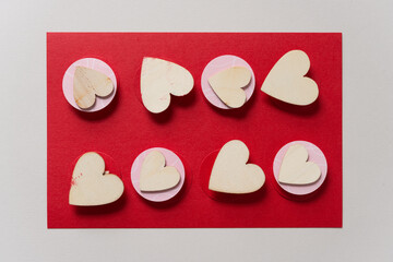 wooden heart shapes on pink paper circles