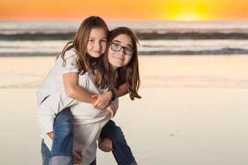 Two Young Sisters Portrait on The Beach.