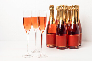 Glasses and bottles of rose champagne or sparkling wine. Christmas, new year party, birthday or wedding celebration concept