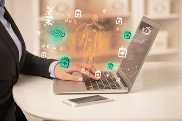 Doctor working on laptop with healthcare concept