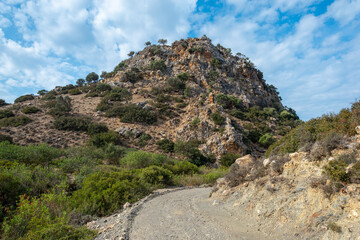 Conical hill on the hiking trail down from Pitsidia to Matala. The huge rock is a landmark, isolated and the only one in this part of Crete. The geological formation looks like a volcanic plug