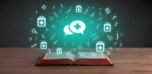 Open medical book with health icons above