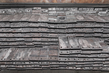 Iron parts of the workpiece for laying railway tracks metal structures in a heap at an industrial plant