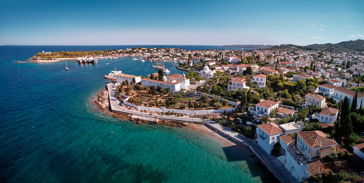 Aerial shot of Spetses Island coast in Greece. A famous tourist destination on the Aegean sea. Old town and harbour view.