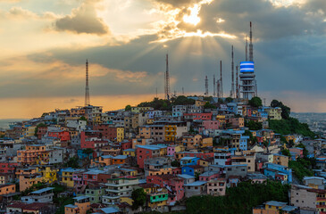 Cerro del Carmel (Carmel Hill) with colorful facades and housing at sunset seen from Santa Ana Hill, Guayaquil, Ecuador.