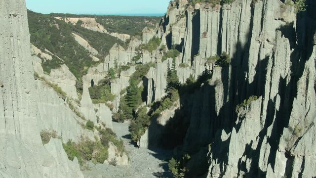 Aerial: Tightly packed cluster of ancient gravel spires at Putangirua Pinnacles, Cape Palliser, New Zealand