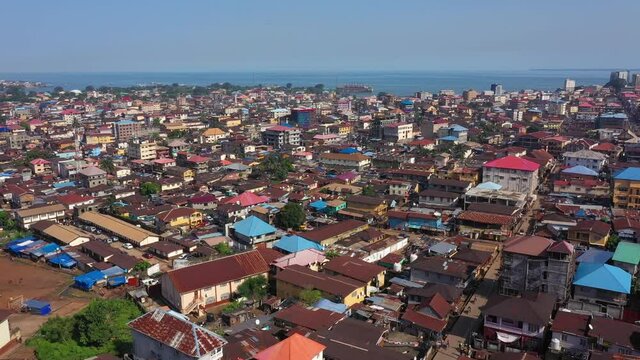 Aerial Freetown city congested building traffic part 2. Coast of west Africa suffers extreme poverty and hunger. Congested crowded homes and businesses. Tropical climate. Transportation bad roads.