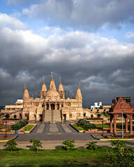 Crowdless Swaminarayan temple on a clear sunny day with clouds background in Ambegaon, Pune,...