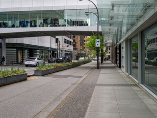 Pedestrian pavement, bike track, and car road in downtown of Vancouver, Canada.