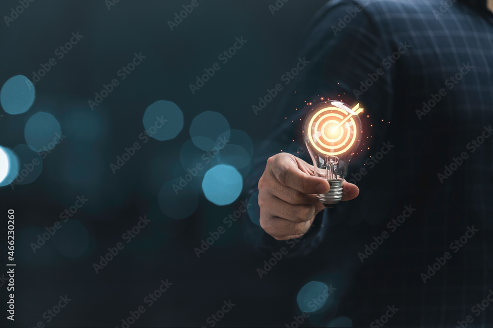 Poster hand holding lightbulb with target board for creative and set up business objective target goal conc