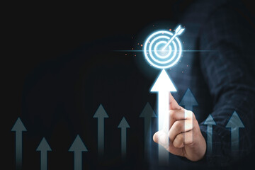 Hand touching up arrow with virtual target board for enhance and set up business objective target ...