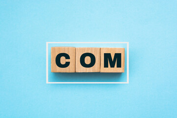 Domain concept. Isolated cube blocks with COM text on blue background. Internet and web