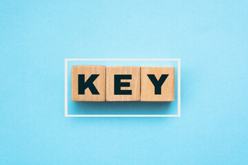 word key on wooden cube blocks on blue background