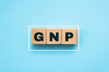 GNP Gross Domestic Product word made with wooden blocks on blue background