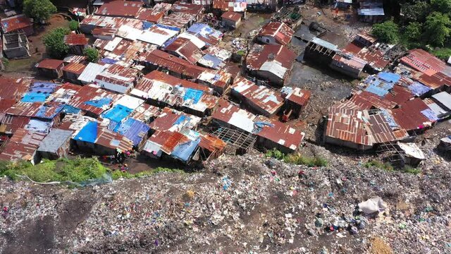 Aerial city garbage dump poverty village Freetown Sierra Leone. West Africa suffers extreme poverty hunger. Crowded homes and businesses. Tropical climate. Bad Transportation infrastructure.