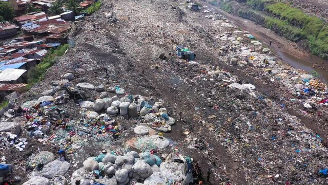 Aerial city garbage dump scavengers Freetown Sierra Leone. West Africa suffers extreme poverty hunger. Crowded homes and businesses. Tropical climate. Bad Transportation infrastructure.