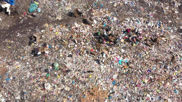Aerial city garbage dump scavengers pigs Freetown Sierra Leone Part 2. West Africa suffers extreme poverty hunger. Crowded homes and businesses. Tropical climate. Bad Transportation infrastructure.