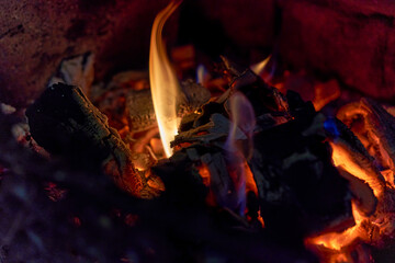Burning black coals and fire bred in the fireplace
