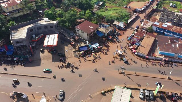 Aerial Freetown Sierra Leone busy intersection motorcycles. Sierra Leone on  coast of west Africa suffers extreme poverty and hunger. Congested crowded homes and businesses. Tropical climate.