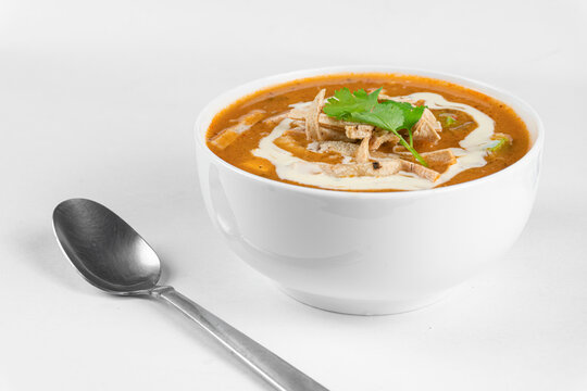 Chicken Tortilla Soup With Fried Strips Of Corn Tortillas. Mexican Soup On White Background