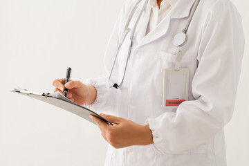 close up of doctor standing and writing medical records on white background.