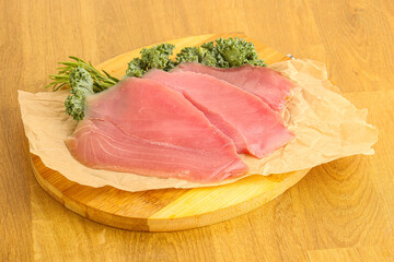 Raw salted tuna slice over board