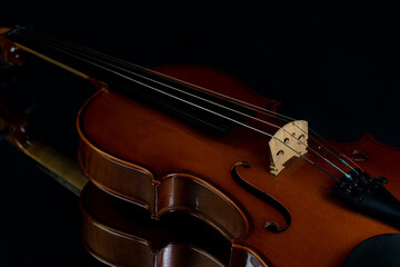 Dramatic close up of red violin on black background. Musical instrument. Classic music concept.