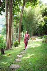 Fototapeta premium Young lady relaxing in the natural park. Vacation on Summer in the garden. Feeling and freedom.Lifestyle Concept.