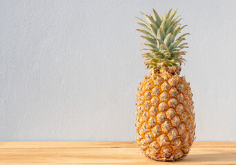 Ripe pineapple isolated on wooden table