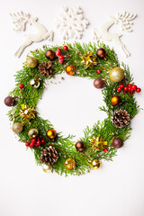 Fototapeta na wymiar Winter and christmas wreath with gold christmas toys on white background.