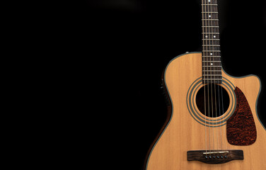 Naklejka na ściany i meble Acoustic guitar on a black background, flat lay, copy space.