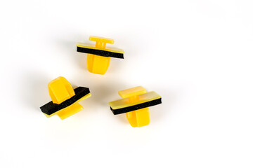 Plastic yellow clips for cars. Close up. Isolated on white background