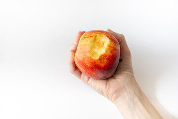 The hand holds a bitten off apple with traces of blood. Periodontics.