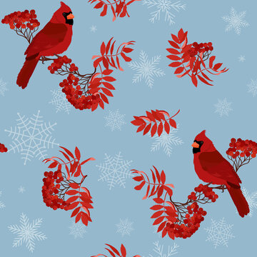 Seamless vector illustration with rowan branches, snowflakes, bird cardinal on a blue background.