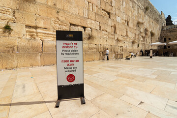 The men's prayer plaza at the Western Wall in Jerusalem, signs on the floor warning people to wear...