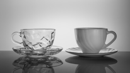 two empty cups on the table with a reflection