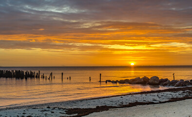 Sunrise in the vicinity of old fishing village, one can see remains of old fishing pier, Baltic Sea