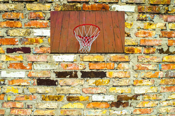Basketball backboard with a ring on a brick wall. Street basketball. Wooden shield with a ring....
