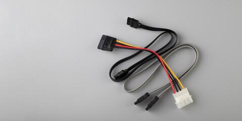 banner, SATA 3.0 data cable and power cable on a gray background, top view, empty space for text