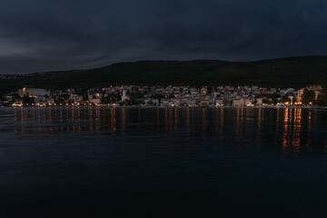 Croatian coast town Selce illuminated at dusk.