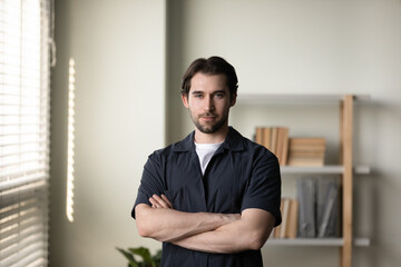 Portrait of happy young handsome successful confident man worker employee boss looking at camera, feeling satisfied with professional corporate career, joyful male homeowner posing in living room.