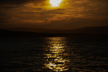 Sunset over the mountains of the Croatian coast. A dark scene.