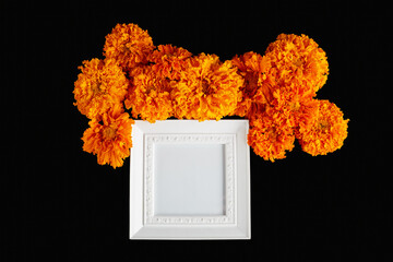 layout of fall frame with place for text. orange flowers on a black background. simple flat lay invitation or greeting banner mockup