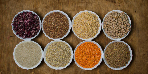 Various cereals on a wooden background. The concept of wholesome food. Vegetarian food