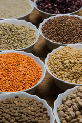 Various cereals on a wooden background. The concept of wholesome food. Vegetarian food